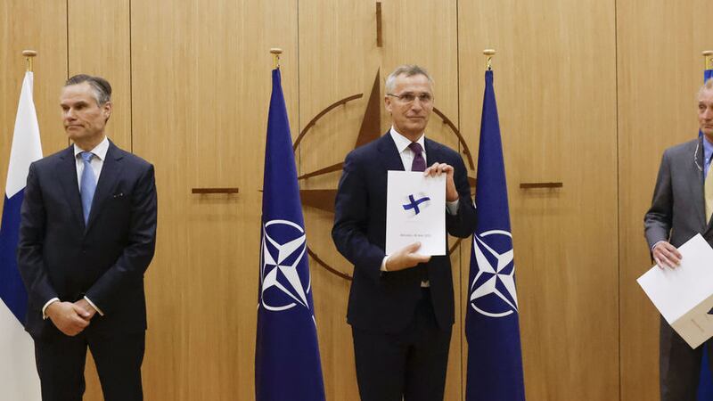Finland's Ambassador to NATO Klaus Korhonen, NATO Secretary-General Jens Stoltenberg and Sweden's Ambassador to NATO Axel Wernhoff attend a ceremony to mark Sweden's and Finland's application for membership in Brussels, Belgium, Wednesday May 18, 2022 (Johanna Geron/Pool via AP)&nbsp;