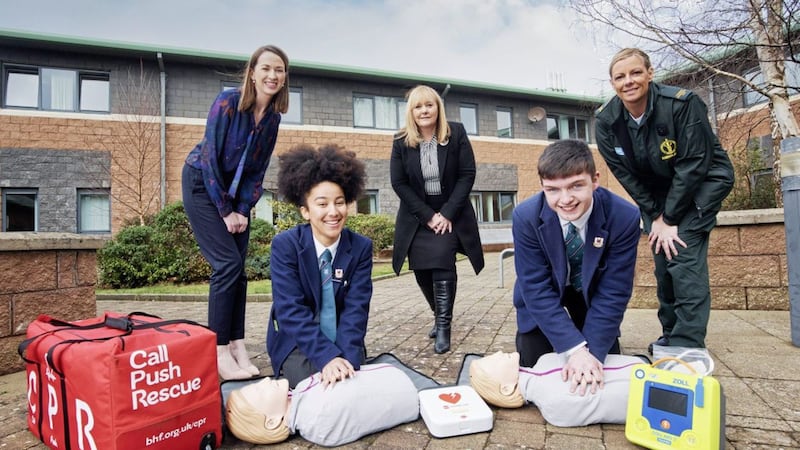 (L -R) Denise McAnena, from the British Heart Foundation, Faith Chitwekwe, Head Girl Wellington College, Education Minister Michelle McIlveen, Ryan McCarroll, Head boy Wellington College and Stephanie Leckey, NI Ambulance Service, practice their life-saving skills after it was announced that CPR and awareness around the use of defibrillators has officially become part of the Northern Ireland school curriculum. Picture by Brian Morrison 