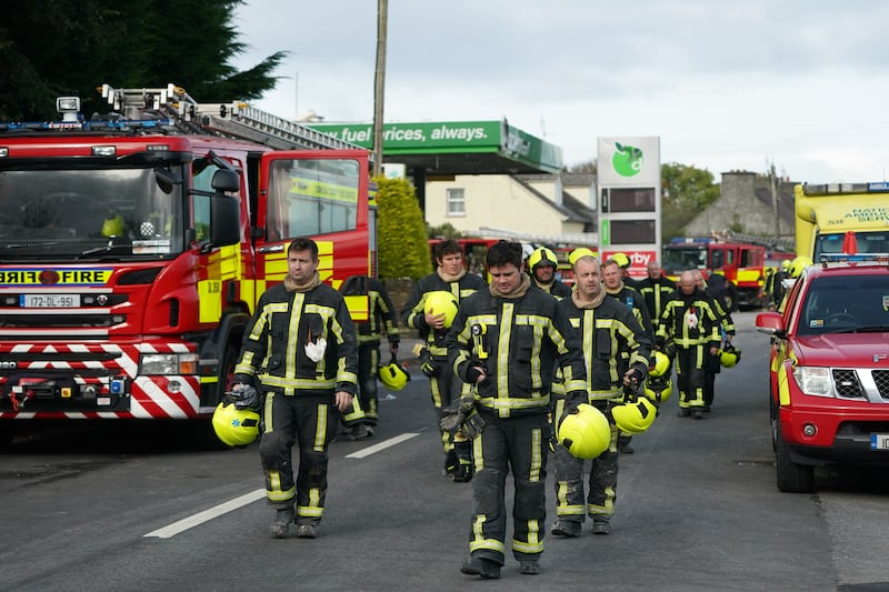 Firefighters leave the scene of an explosion at Applegreen service station in the village of Creeslough in Co Donegal, where ten people have now been confirmed dead.