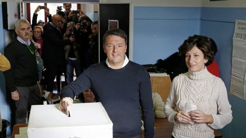 Italian Premier Matteo Renzi is flanked by his wife Agnese as he casts his ballot at a polling station in Pontassieve, Italy. Picture by Antonio Calanni, Associated Press