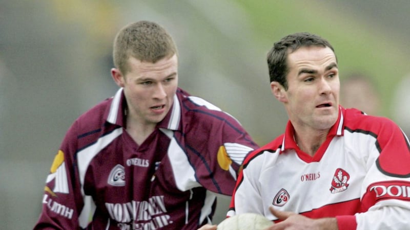 Derry star Sean Marty Lockhart holds on to possession despite pressure from Galway&#39;s Tomas Costello 