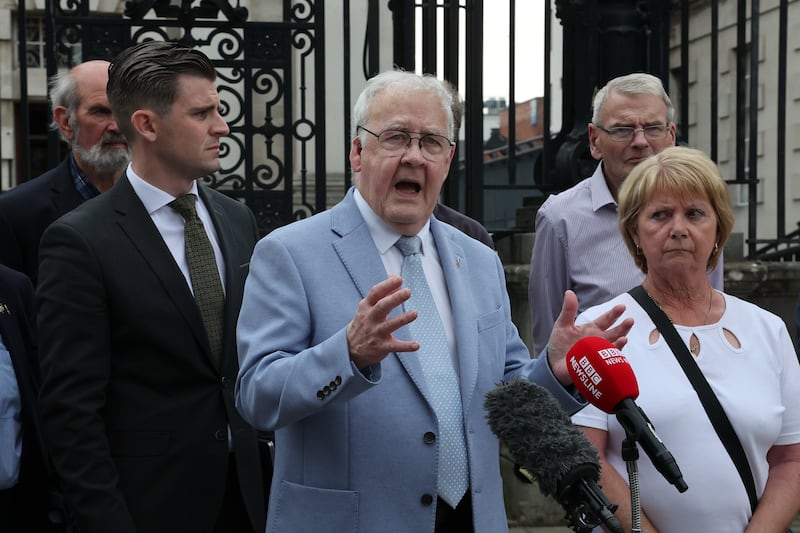 Francis McGuigan of The Hooded Men and families outside the High Court. Picture by Hugh Russell