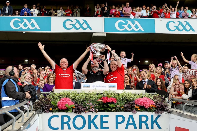 Cork management team Matthew Twomey lifts the O'Duffy Cup
