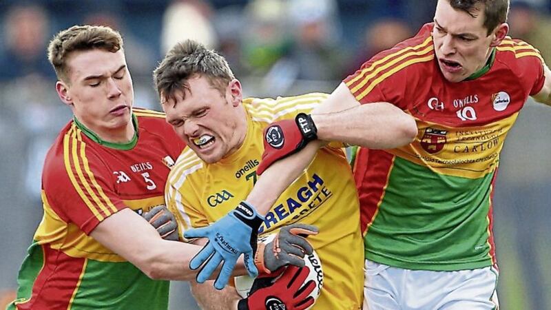 Antrim's James Laverty tries to get away from Carlow's Jordan Morrissey and Sean Gannon.<br /> Picture by Cliff Donaldson.