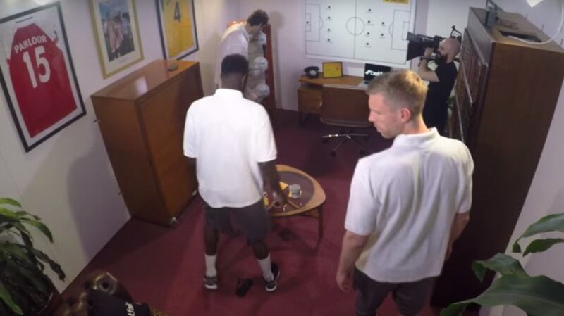Arsenal players attempt to solve clues in an escape room