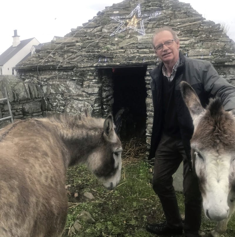 John McIlmail with donkeys Maggie and Rosie outside his farm&#39;s tiny pig sty, which was built in Norman times. 