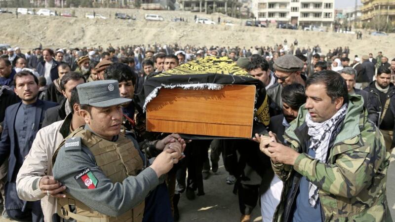 Mourners carry the coffin of a relative who died in Saturday&#39;s deadly suicide attack in Kabul Picture by Rahmat Gul/AP 