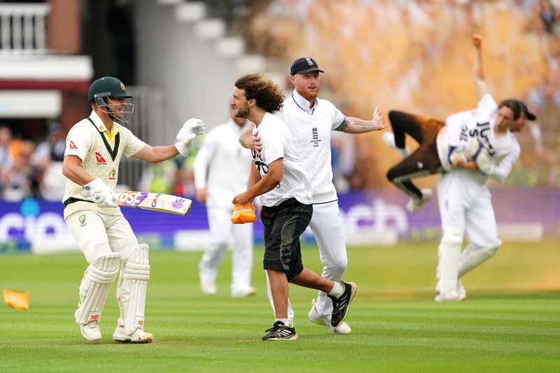 England’s Ben Stokes (centre) grabs a Just Stop Oil protestor whilst Johnny Bairstow (right) carries another protester off the field during day one of the second Ashes test match at Lord’s, London on June 28. 