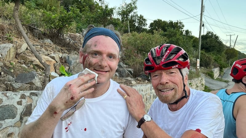 Richard Branson (right) with injuries standing with another man with injuries