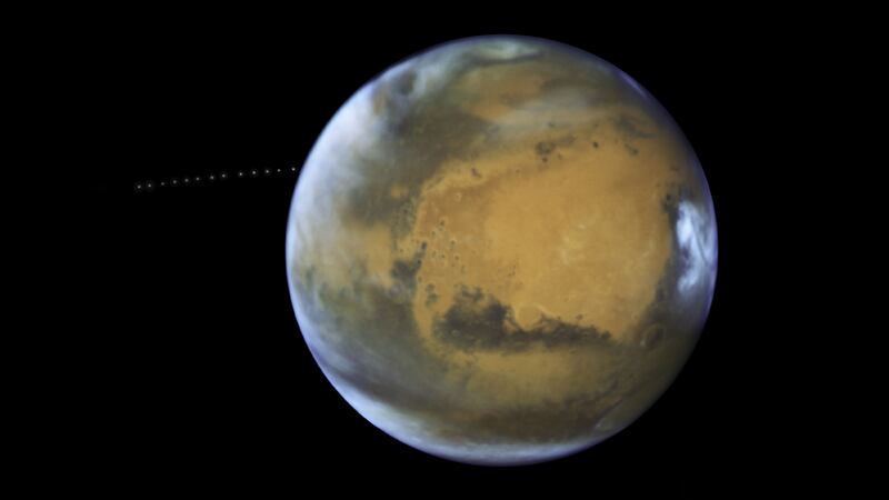Nasa’s Hubble Space Telescope captured incredible images of the Red Planet and one of its natural satellites.