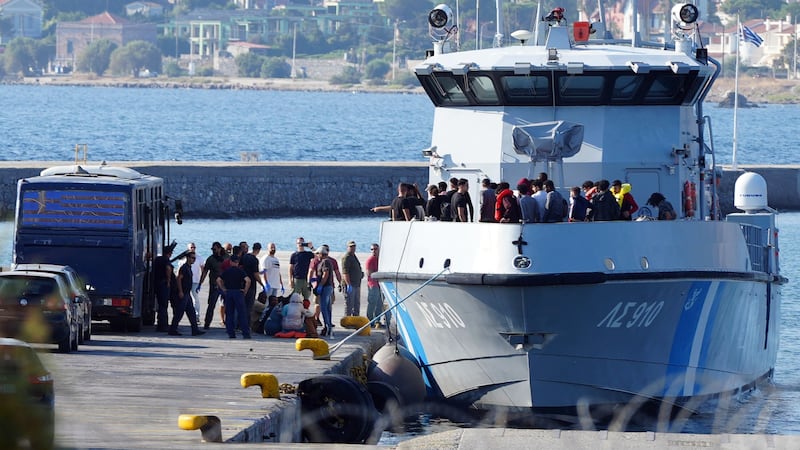Migrants disembark from a Greek coastguard vessel in Mytilene, Lesbos (AP Photo/Panagiotis Balaskas)