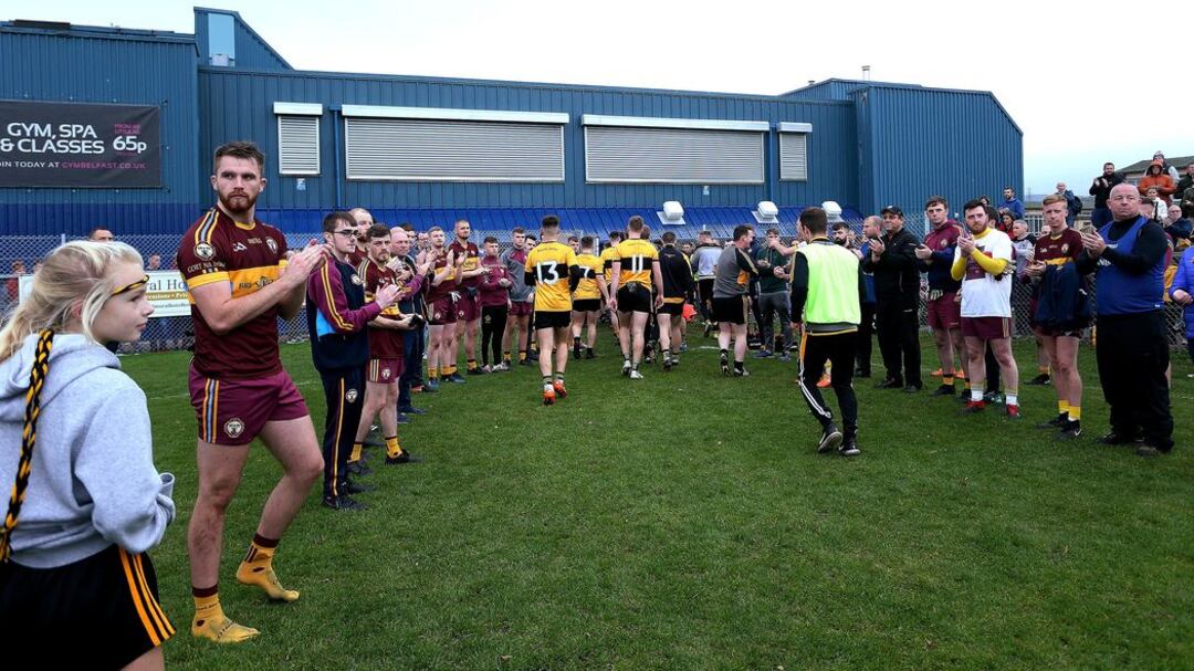 The St Enda's players are applauded off the pitch by Gort na Mona after the Glengormley side had won their Antrim Intermediate Football Championship final at Corrigan Park last weekend Picture by Seamus Loughran