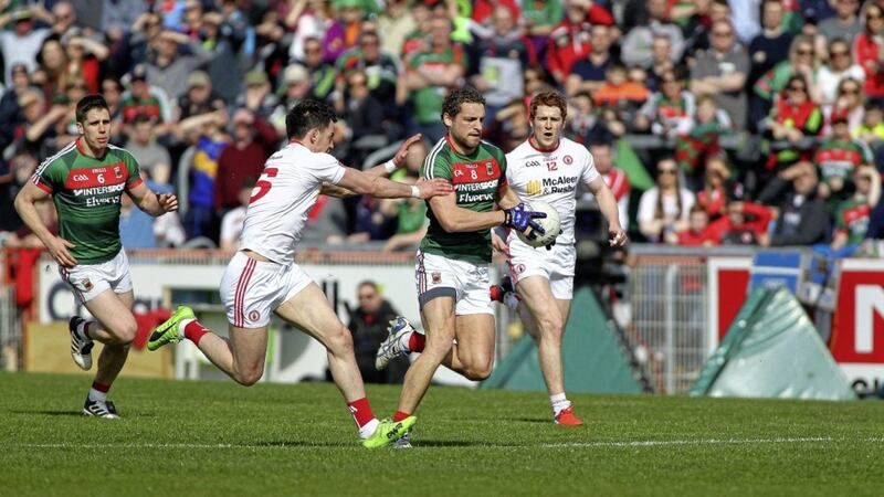 Mayo&#39;s Tom Parsons with Lee Keegan comes under pressure from Tyrone&#39;s Mattie Donnelly and Peter Harte at Healy Park. Picture by Seamus Loughran. 