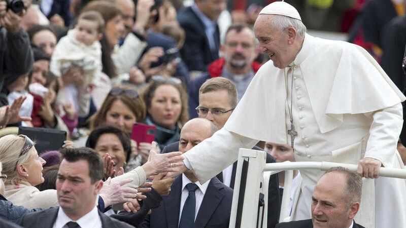 Pope Francis greets faithful as he arrives for his weekly general audience in St Peter&rsquo;s Square, at the Vatican, on Wednesday. Picture by Andrew Medichini/AP