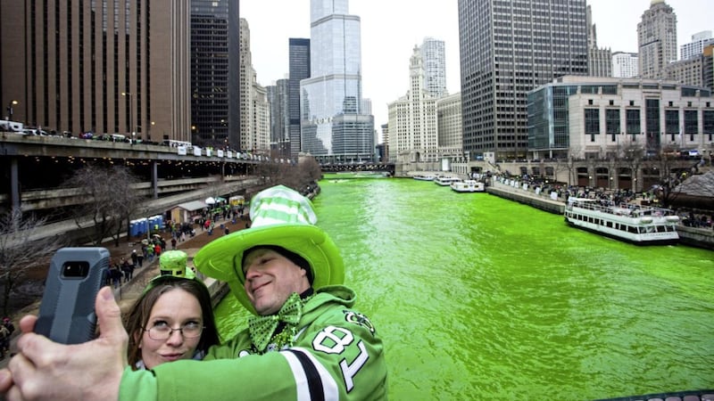 Stacey Peterson and Kevin McGuire take a selfie in front of the green Chicago River to celebrate St. Patrick&#39;s Day. Photo by James Foster/Chicago Sun-Times via AP 