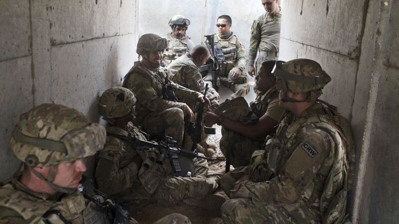 US military personnel sit in a bunker as an incoming mortar alarm is called at a coalition air base in Qayara, 50 kilometers south of Mosul, Iraq, Picture: Marko Drobnjakovic/AP 