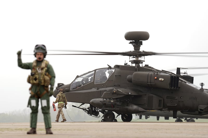 British Army Apache AH-64E attack helicopters are prepared for take off from Wattisham Flying Station in Suffolk