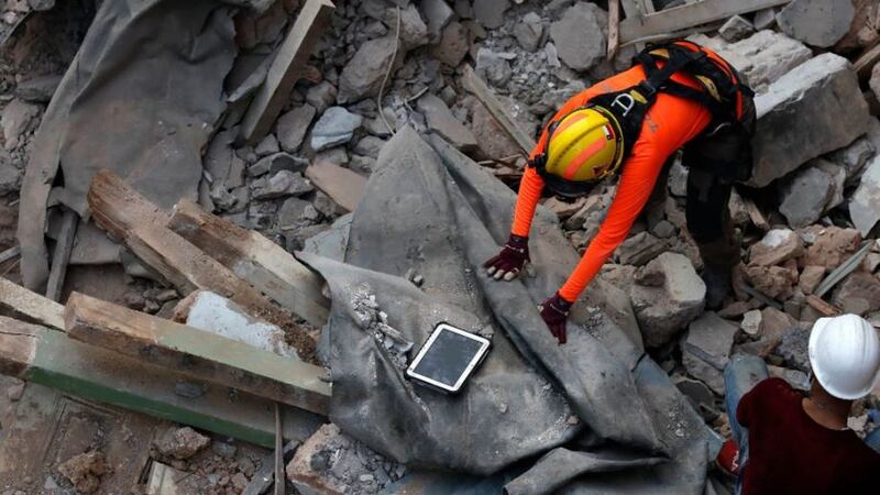 &nbsp;A Chilean rescuer uses a sound track machine at the site of a collapsed building after getting signals there may be a survivor under the rubble in Beirut, Lebanon, on September 4 2020.Picture by Hussein Malla, AP