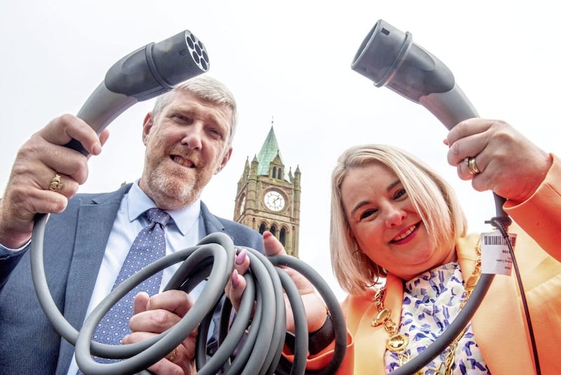 Stormont infrastructure minister John O&rsquo;Dowd pictured last month with Derry City and Strabane District Council Mayor Sandra Duffy. The council has led a consortium of councils in a bid for funding which will see 124 EV charge-points installed in residential areas that do not have access to private off-street parking and charging. But further initiatives of this sort are needed to help allay drivers&#39; concerns about recharging electric cars. Picture by Martin McKeown. 