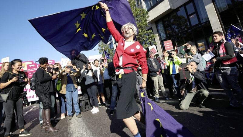 An anti-Brexit campaigner dressed as Theresa May waves European Union flags during the People&#39;s Vote March for the Future in London on Saturday. Picture by Yui Mok, Press Association 