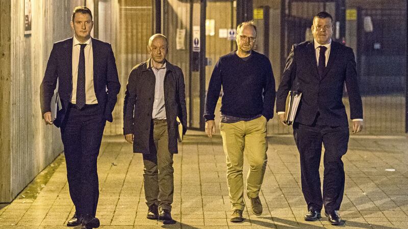 From left, solicitor John Finucane with his client, investigative journalist Barry McCaffrey, and Trevor Birney with his solicitor Niall Murphy leaving Musgrave police station in Belfast on Friday night. Picture by&nbsp;Liam McBurney/PA