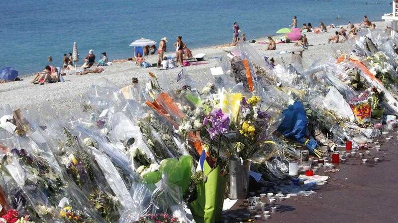 Flowers and messages are placed along the beach of the Promenade des Anglais in Nice, southern France on Wednesday. Picture: Claude Paris/AP 