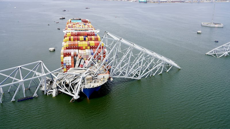 The cargo ship Dali stuck under part of the structure of the Francis Scott Key Bridge after the ship hit the bridge in Baltimore (Maryland National Guard via AP)