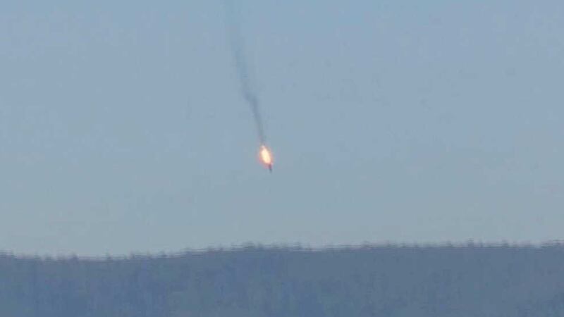 This frame grab from video by Haberturk TV, shows a Russian warplane on fire before crashing on a hill as seen from Hatay province, Turkey, Tuesday, November 24, 2015&nbsp;