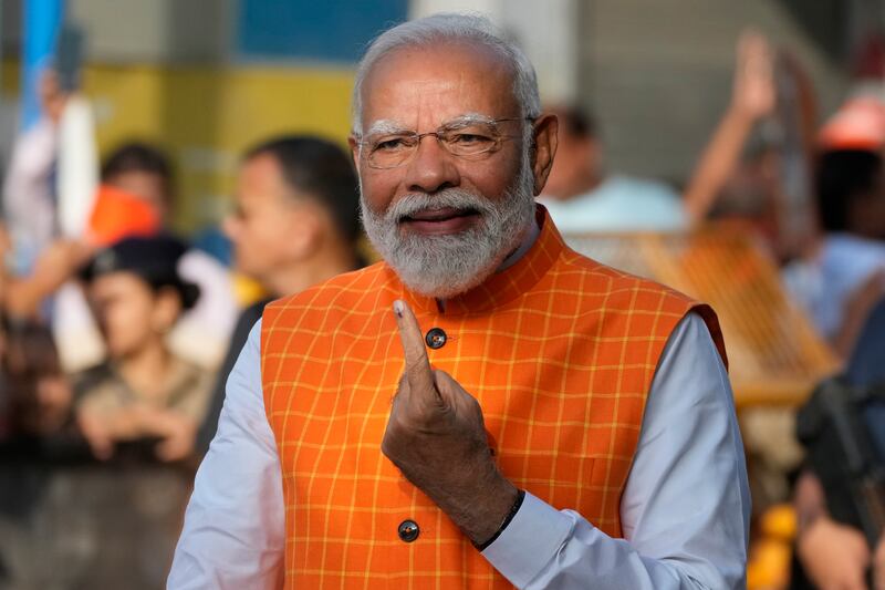 Indian prime minister Narendra Modi, shows the indelible ink mark on his index finger after casting his vote during the third phase of general elections, in Ahmedabad, Gujarat (Ajit Solanki/AP)