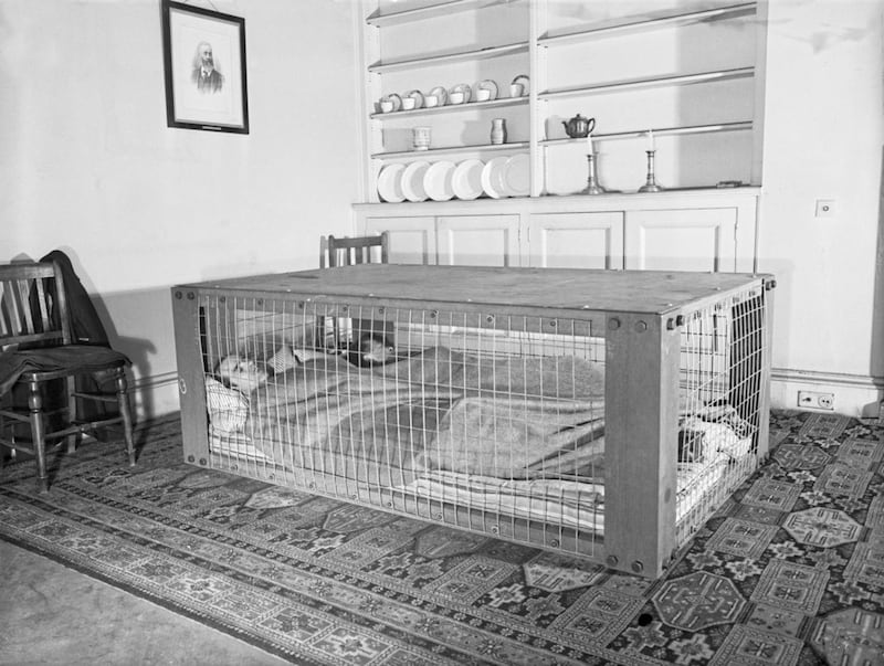 A couple demonstrate a Morrison shelter, which, with detachable sides, doubled as a table, during the Second World War. By 1945 more than a million were in use. Picture by Imperial War Museums 