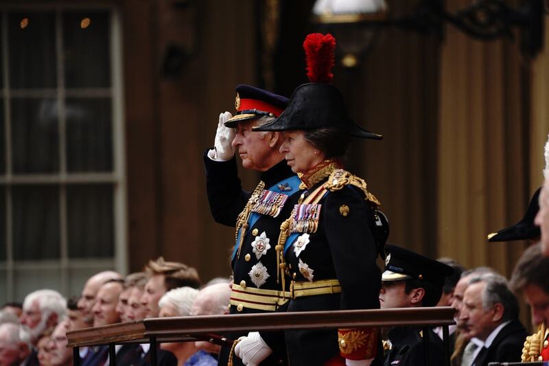 The King salutes, alongside the Princess Royal, during the ceremony 
