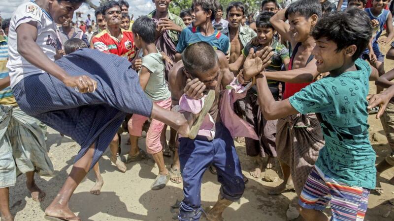 Rohingya Muslims, who recently crossed over from Myanmar, beat and kick a man suspected to be a child lifter near Balukhali refugee camp, Bangladesh PICTURE: Dar Yasin/AP 
