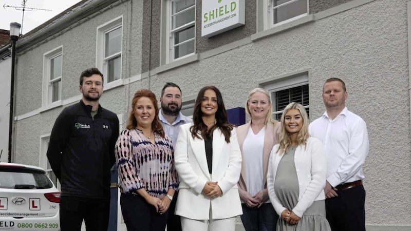Shield Accident Management, Monica Hughes (centre), with company ambassador and Tyrone GAA star, Conor McKenna (left) and staff: Fiona Anderson, Stephen McCann, Joanne McCusker, Kiera Rooney and David Tate. 