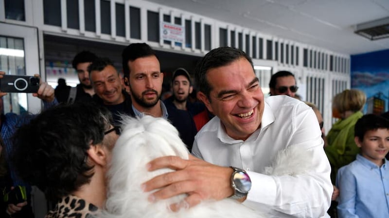 Alexis Tsipras, leader of the main opposition Syriza party, greeting his supporters at a polling station in Athens, Greece (Michael Varaklas/AP)