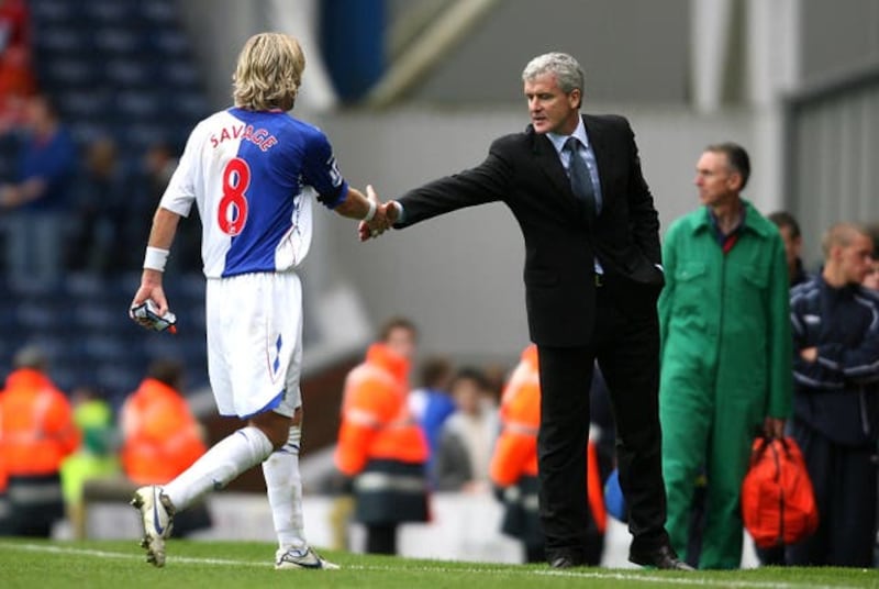 Robbie Savage shakes hands with Mark Hughes