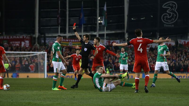 Neil Taylor of Wales receives a red card as Ireland captain Seamus Coleman suffers a broken leg during last night's World Cup qualifier