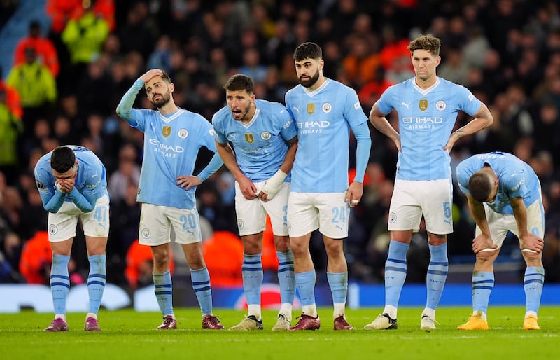 Manchester City players look on dejected during the penalty shoot out