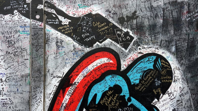 Signatures and messages from tourists scrawled on a Belfast peace wall. Picture: Frankie Quinn