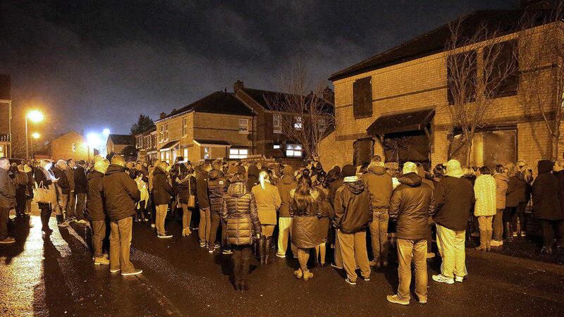 People gather for a vigil outside the home of 31-year-old Conor McKee who was shot at his Glenpark Street home at the weekend. Picture by Cliff Donaldson. 