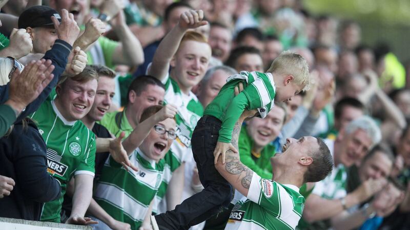 Celtic's Leigh Griffiths celebrates scoring his side's first goal of the game with his son Rhys during the Scottish Premiership match at McDiarmid Park
