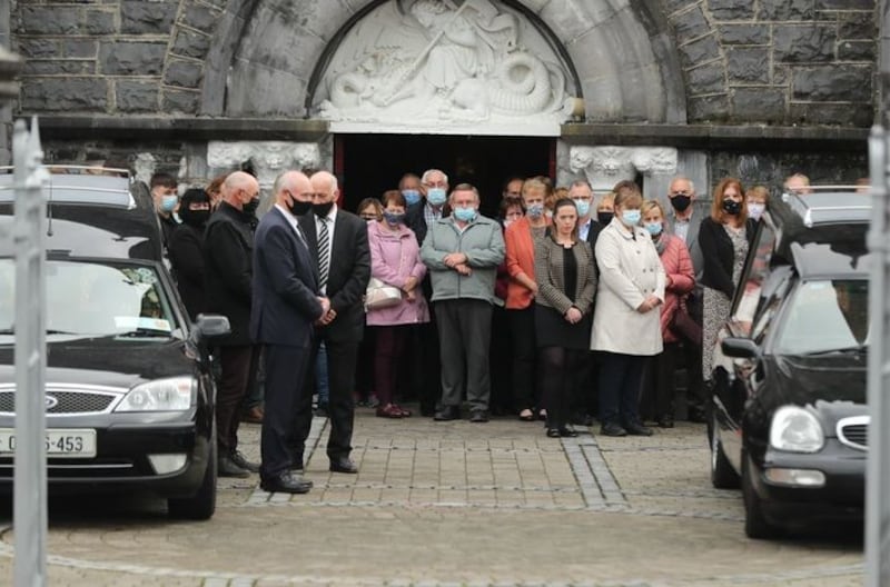 &nbsp;Mourners watch the coffins of Eileen and Jamie O'Sullivan leave St Michael's Church in Lixnaw in North County Kerry.