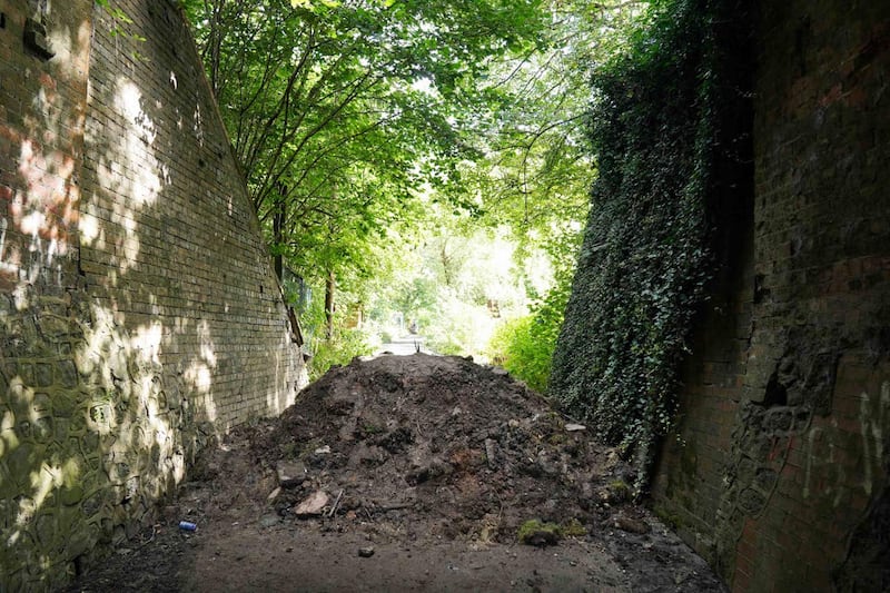 A blocked road leading to the burnt out remains of The Crooked House (Jacob King/PA)
