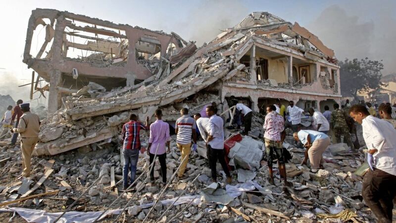 Somalis search for survivors close to destroyed buildings at the scene of Saturday&#39;s blast in the capital Mogadishu PICTURE: Farah Abdi Warsameh/AP 