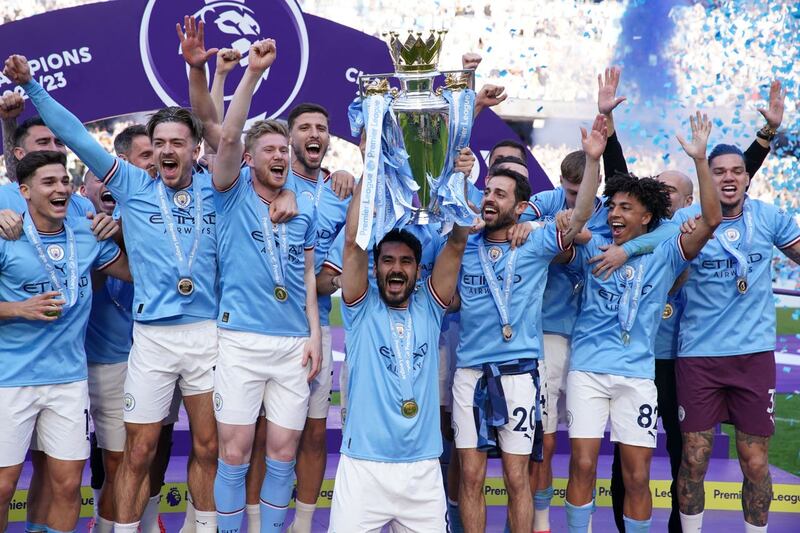 Manchester City celebrate with the Premier League trophy
