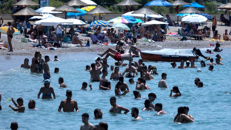Swimmers enjoy the sea in Athens, Greece, amid the heatwave (Yorgos Karahalis/AP)