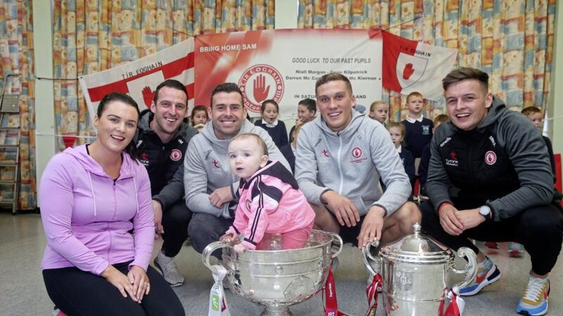 Past pupils of Edendork Primary School and Tyrone GAA players Darren McCurry, Shea Hamill, Conn Kilpatrick, Niall Morgan return to their former primary school with the Sam Maguire and Anglo Celt cups pictured with teacher Joanne Quinn and her baby Kate. Picture by Mal McCann. 