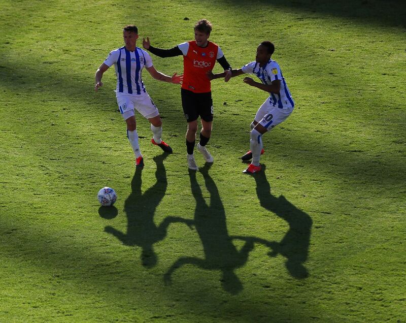 Huddersfield players Jonathan Hogg and Chris Willock battling for the ball
