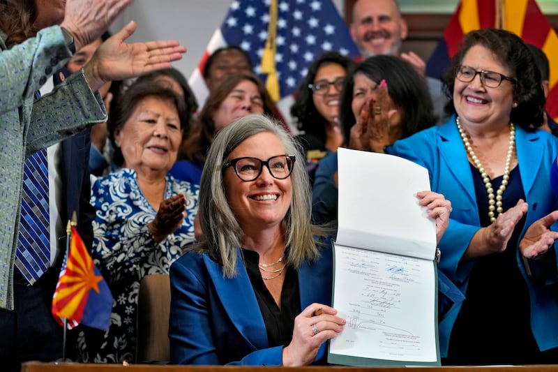 Katie Hobbs holds up the repeal of the near-total abortion ban at the Capitol in Phoenix (AP Photo/Matt York)