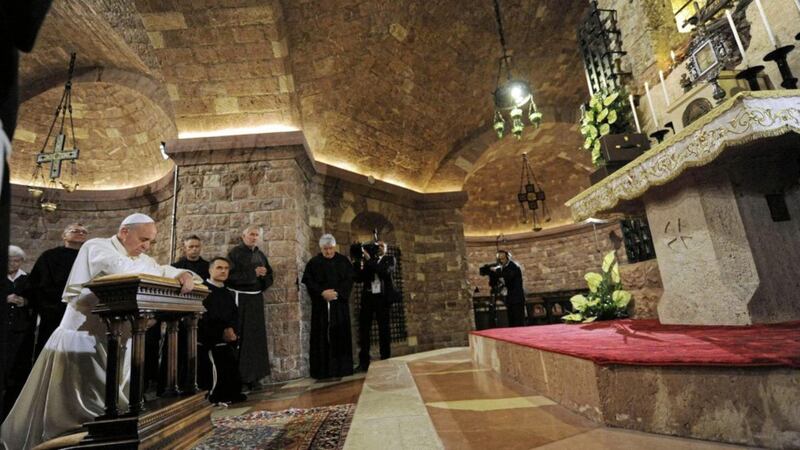 Pope Francis prays at the tomb of St Francis during a visit to Assisi on October 4 2013. It was his first visit to Assisi after taking the name of the great saint for his papacy. Pope Francis returns to Assisi next week to sign his new encyclical, Fratelli tutti. Picture by Crocchioni/AFP/Getty Images 
