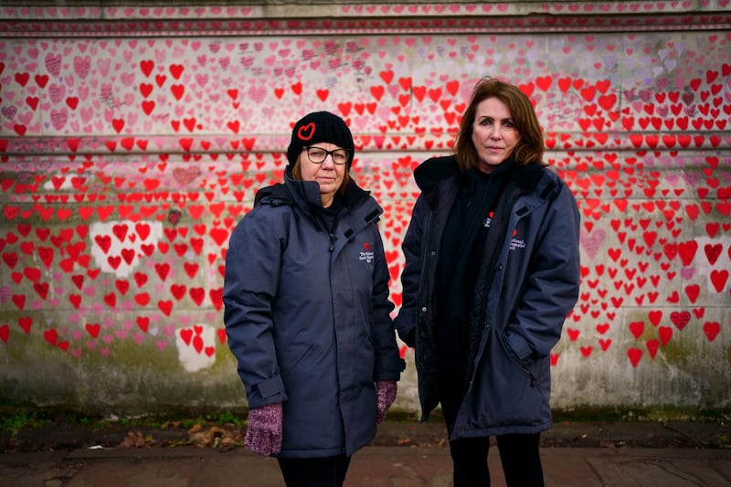 Lynn Jones (left) and Fran Hall from the Covid-19 Bereaved Families For Justice campaign group, standing by the National Covid Memorial Wall in Westminster
